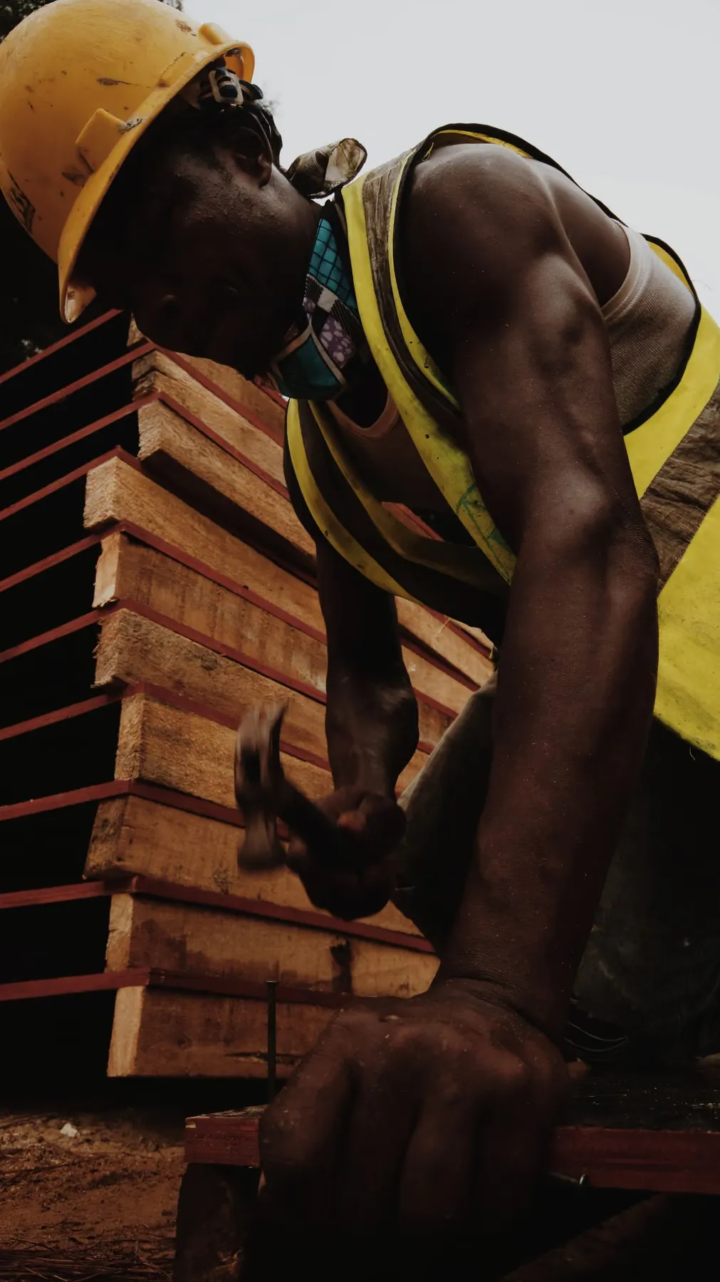 A worker hammering on a construction site