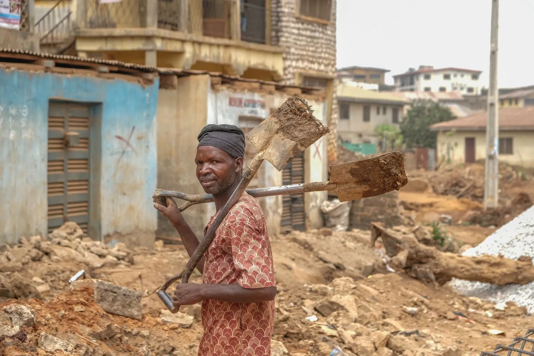 A site worker carrying materials at an OHNEX project