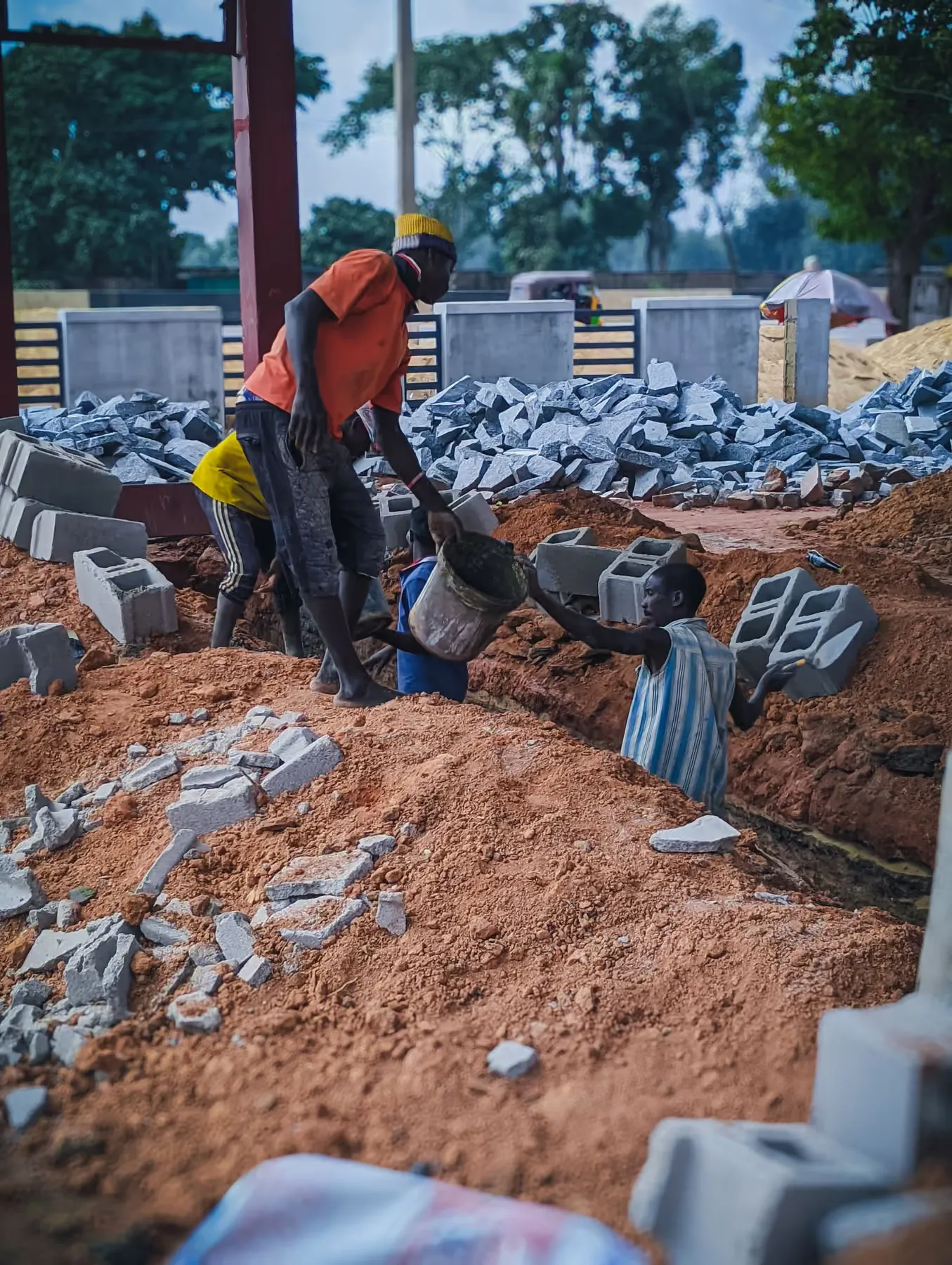 Bricklayers laying blocks on an OHNEX site